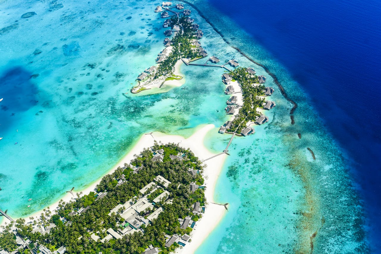 Stunning aerial shot of Maldives islands with turquoise waters and white sand beaches.